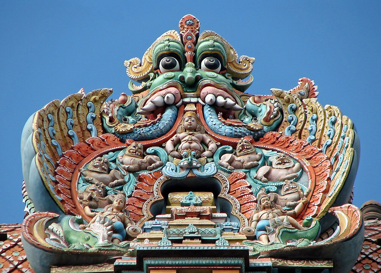 Color photograph of a tall, sculpted gopuram at the Meenakshi Temple in Madurai.