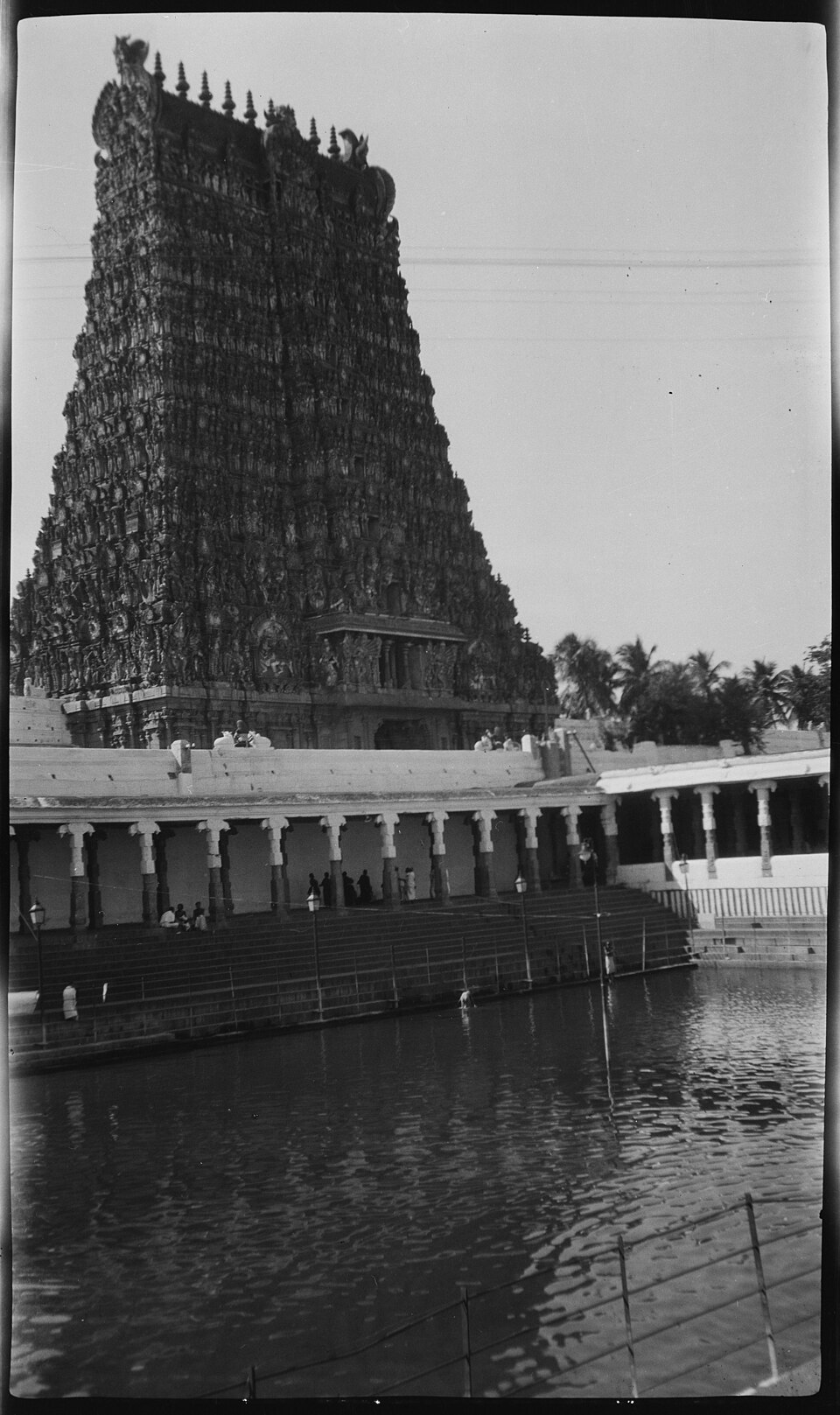 Photograph from 1923 showing the Golden Lily tank with the southern gopuram of the Meenakshi Temple behind it.